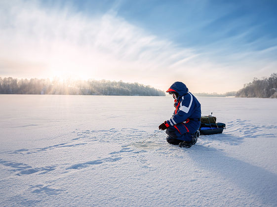 Pêcheur sur un lac gelé en Finlande